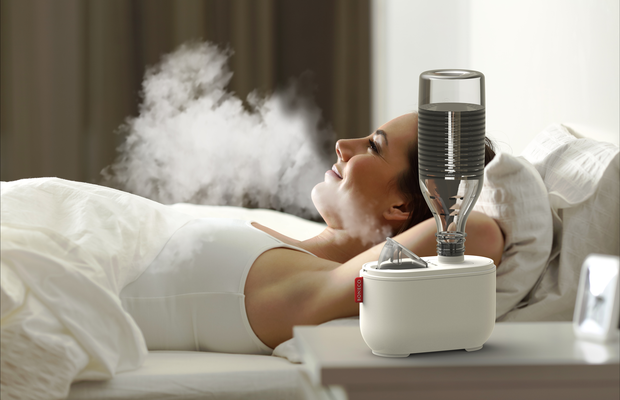 U100 ultrasonic travel humidifier BONECO woman relaxing in bed without light